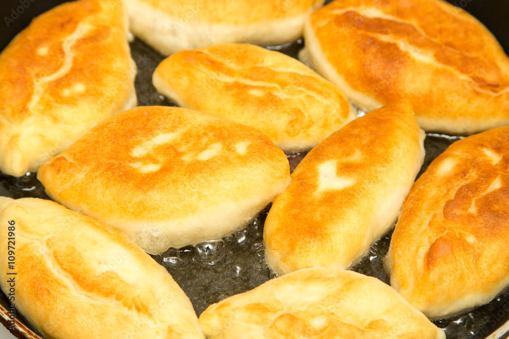 Food patties in a frying pan Food patties in a frying pan