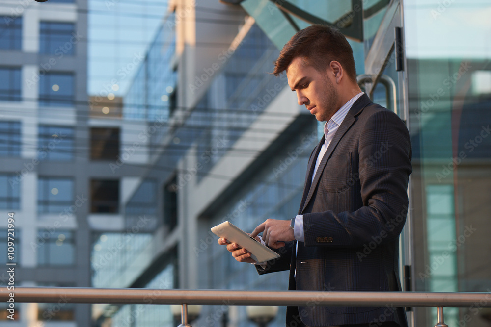 Businessman holding a tablet and pointing finger of the other hand on tablet Businessman holding a tablet and pointing finger of the other hand on tablet