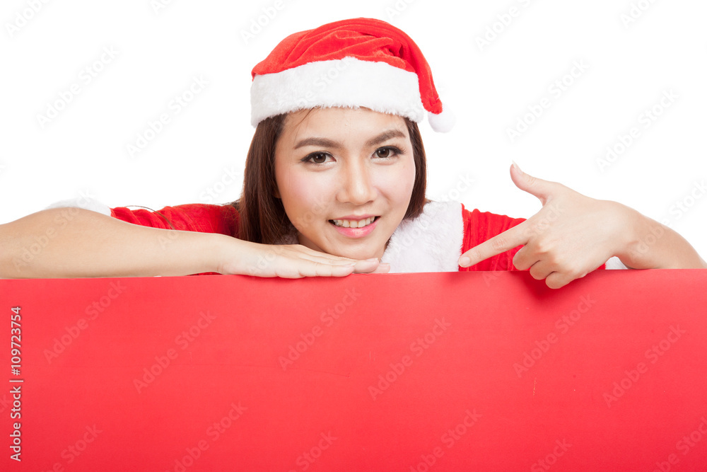 Asian Christmas girl with Santa Claus clothes point down to blan Asian Christmas girl with Santa Claus clothes point down to blan