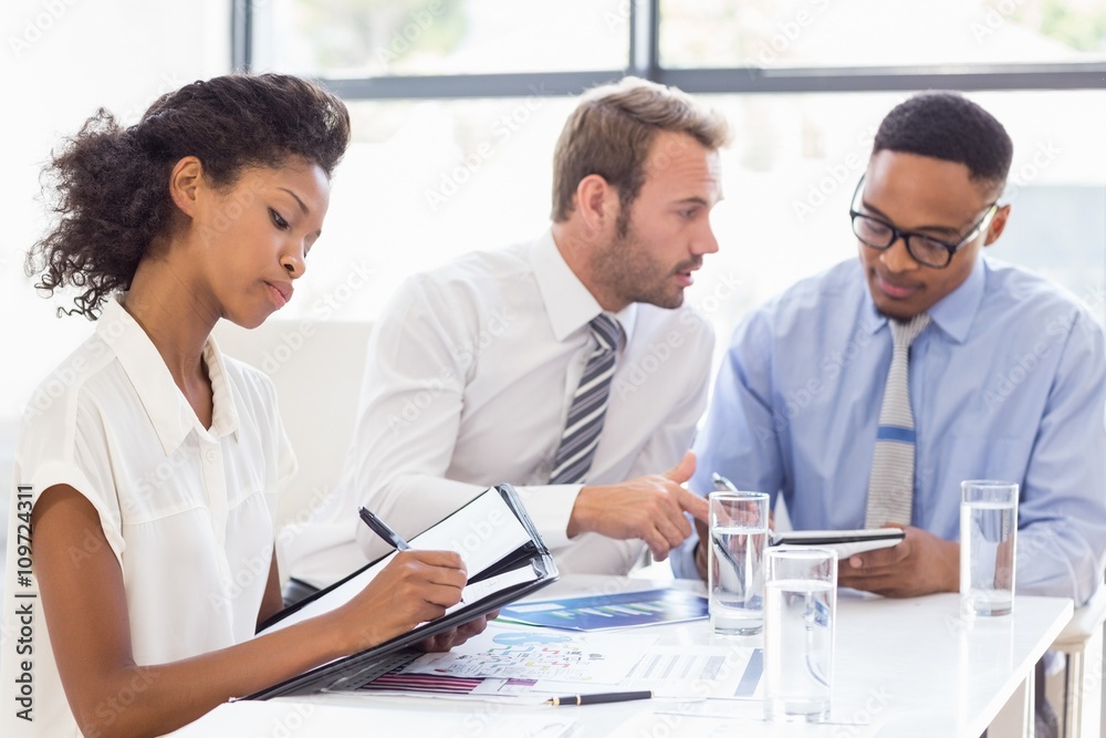 Business colleagues discussing a report Business colleagues discussing a report