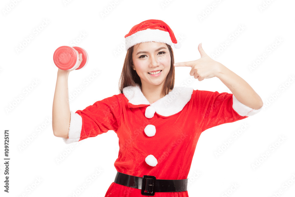Asian Christmas girl with Santa Claus clothes point to red dumbb Asian Christmas girl with Santa Claus clothes point to red dumbb