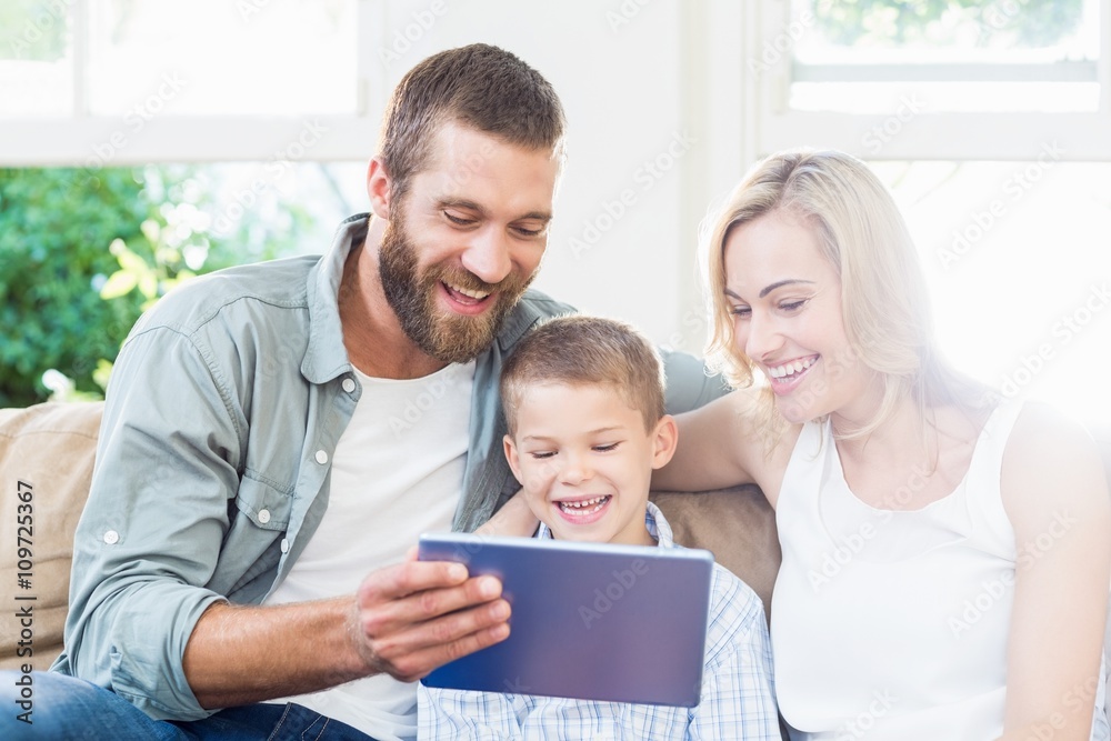 Family using digital tablet in living room Family using digital tablet in living room