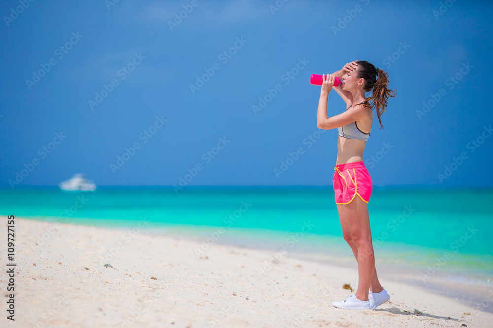 Active fit young woman in her sportswear during beach vacation Active fit young woman in her sportswear during beach vacation
