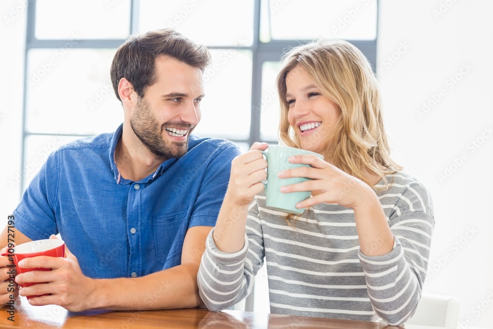 Young couple holding coffee mug
