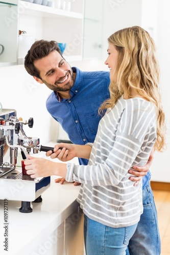 Valokuvatapetti Young couple preparing coffee from coffeemaker