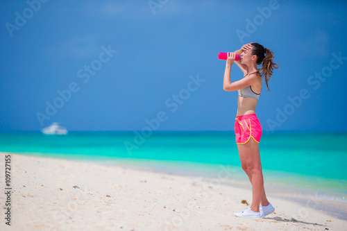 Active fit young woman in her sportswear during beach vacation