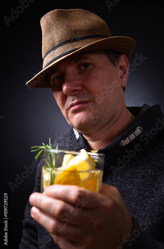 man with glass of alcoholic drink