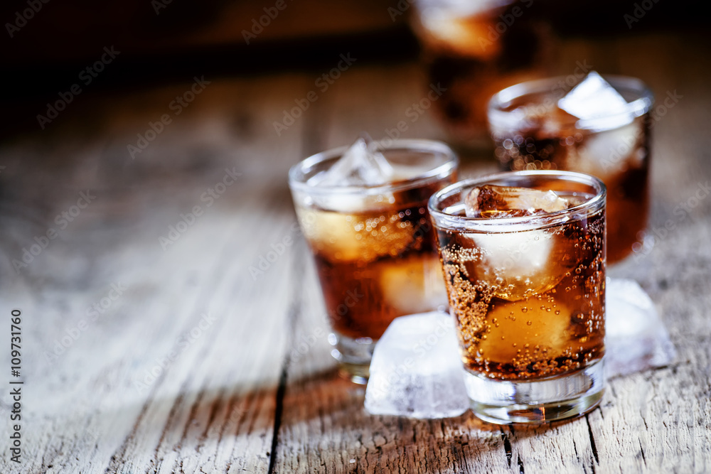 Alcoholic cocktail bourbon cola with whiskey and ice cubes, vint Stock