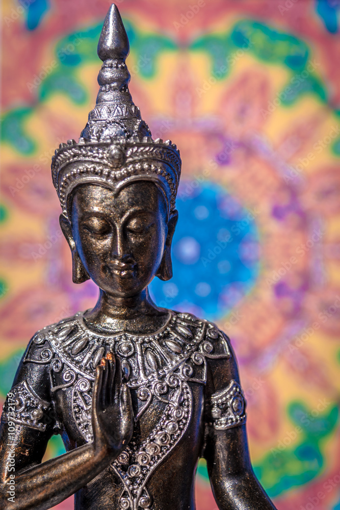 Buddha statue with soft colored mandala background Buddha statue with soft colored mandala background