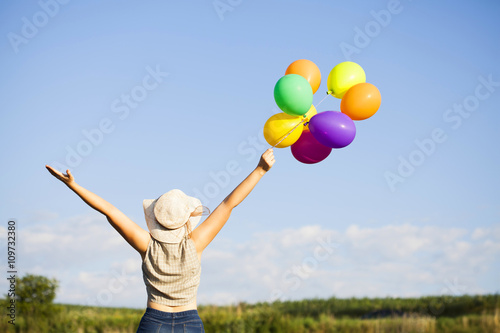 Young woman with colorful ballons