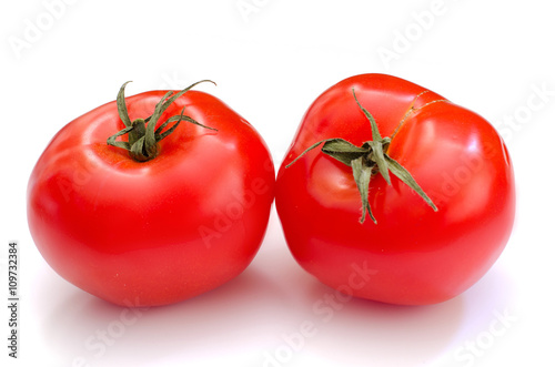Two whole tomatoes on the white background