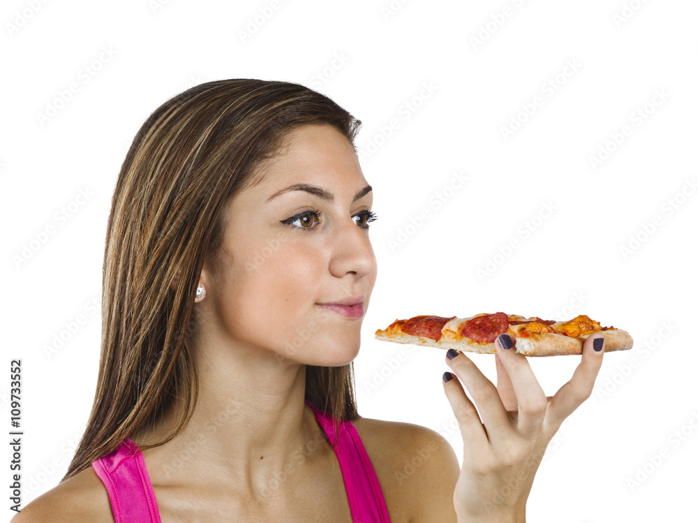 teenage girl looking away while holding a slice of pizza.