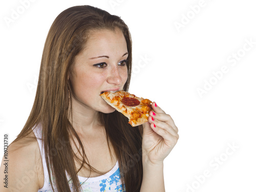teenage girl eating a slice of pizza.