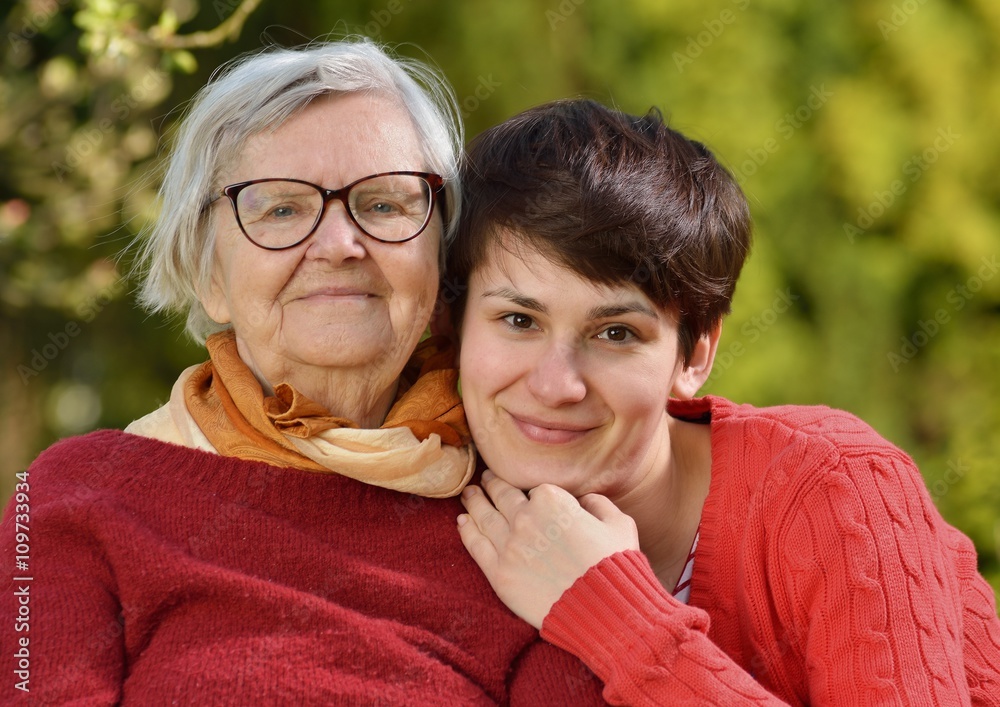 Grandmother and granddaughter. Young woman carefully takes care
