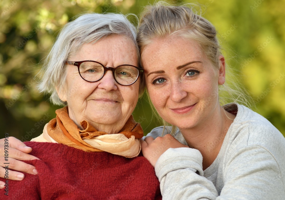 Grandmother and granddaughter. Young woman carefully takes care