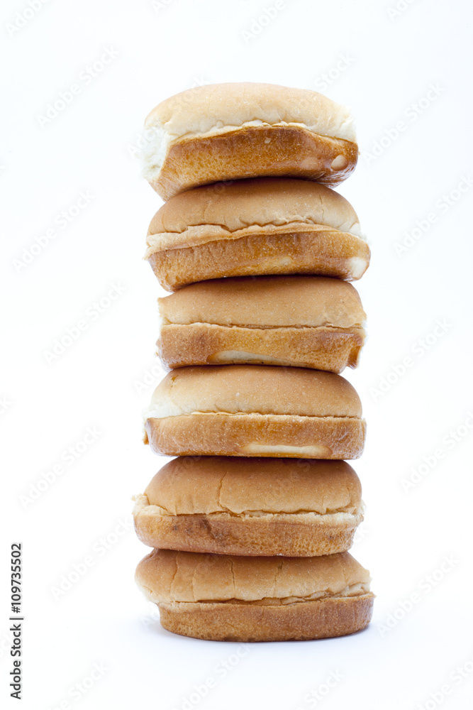 pile of burger buns arranged against white background.