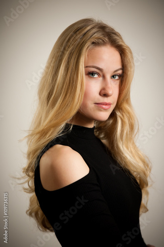 Beautiful young woman with gorgeous hairstyle posing over white