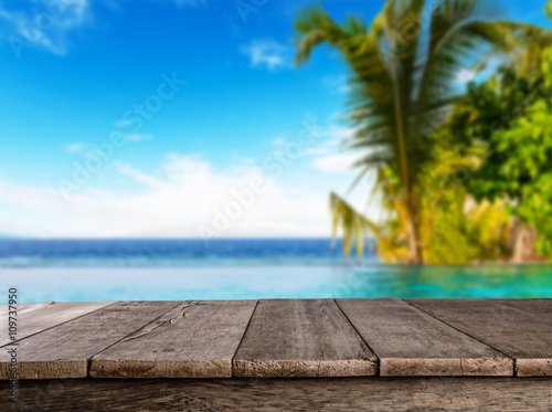 Fototapeta Naklejka Na Ścianę i Meble -  Empty wooden planks with blur beach on background