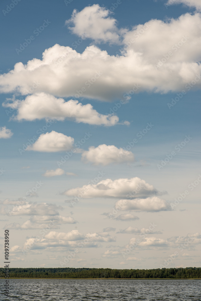 Beautiful summer lake, on background of forest and cloudy sky Beautiful summer lake, on background of forest and cloudy sky