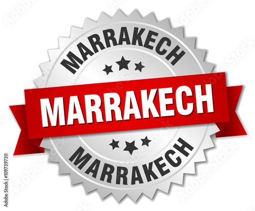 Marrakech  round silver badge with red ribbon