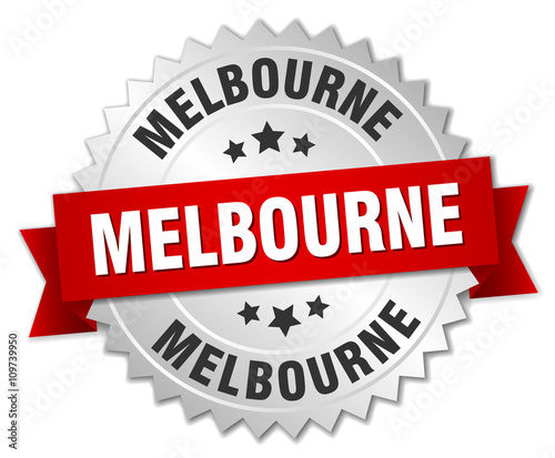Melbourne round silver badge with red ribbon
