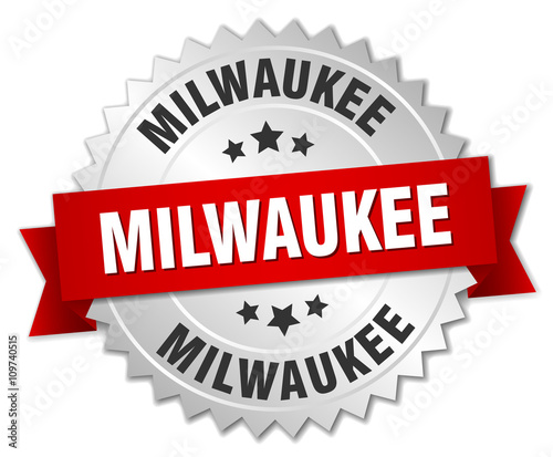 Milwaukee  round silver badge with red ribbon