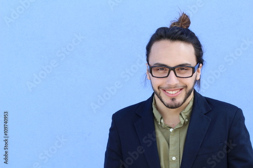 business, startup, inspiration and people concept - happy Mediterranean man with beard and hair bun. Copy space on the left. photo