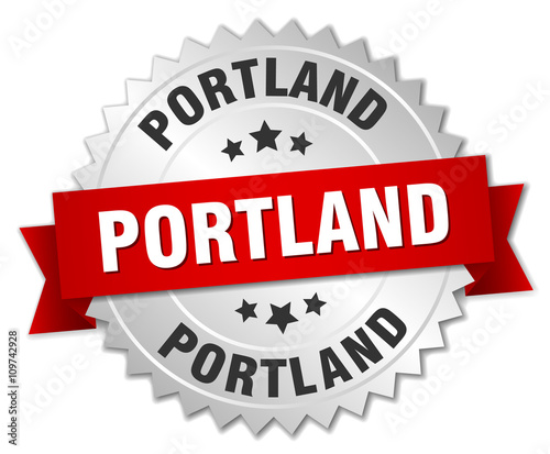Portland round silver badge with red ribbon