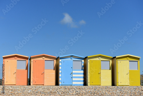 Row of colourful beech huts and blue sky © Peter Cripps