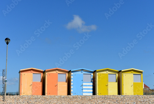 Row of colourful beech huts and blue sky