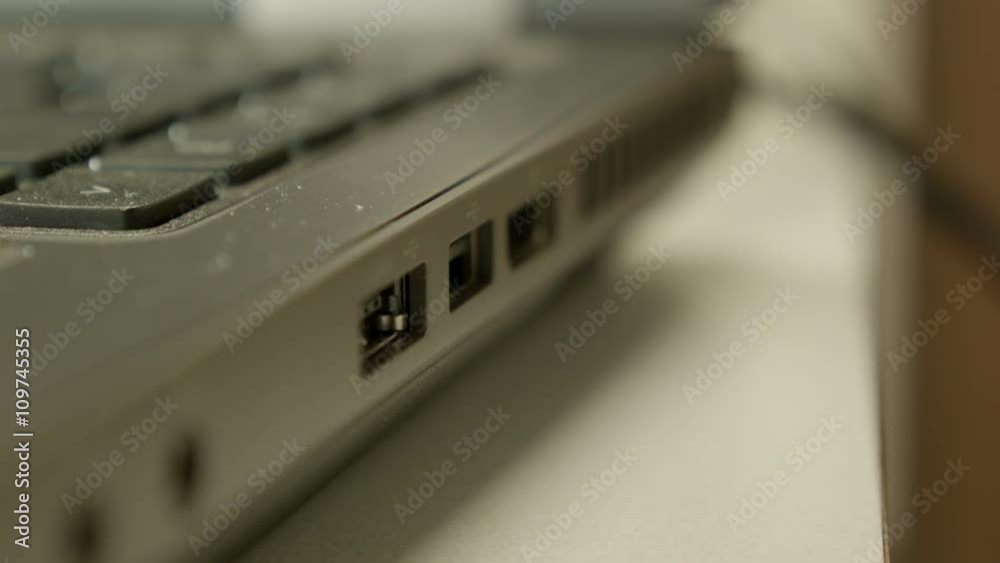 Technician plugging in and unplugging a USB connector to an open port