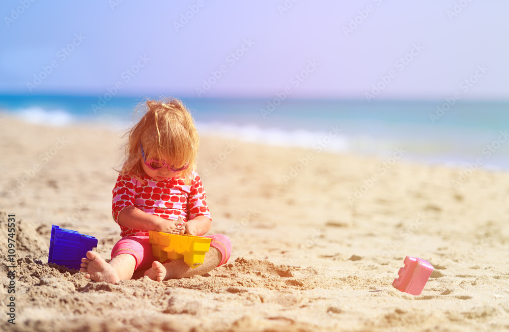 little girl play with toys on beach little girl play with toys on beach