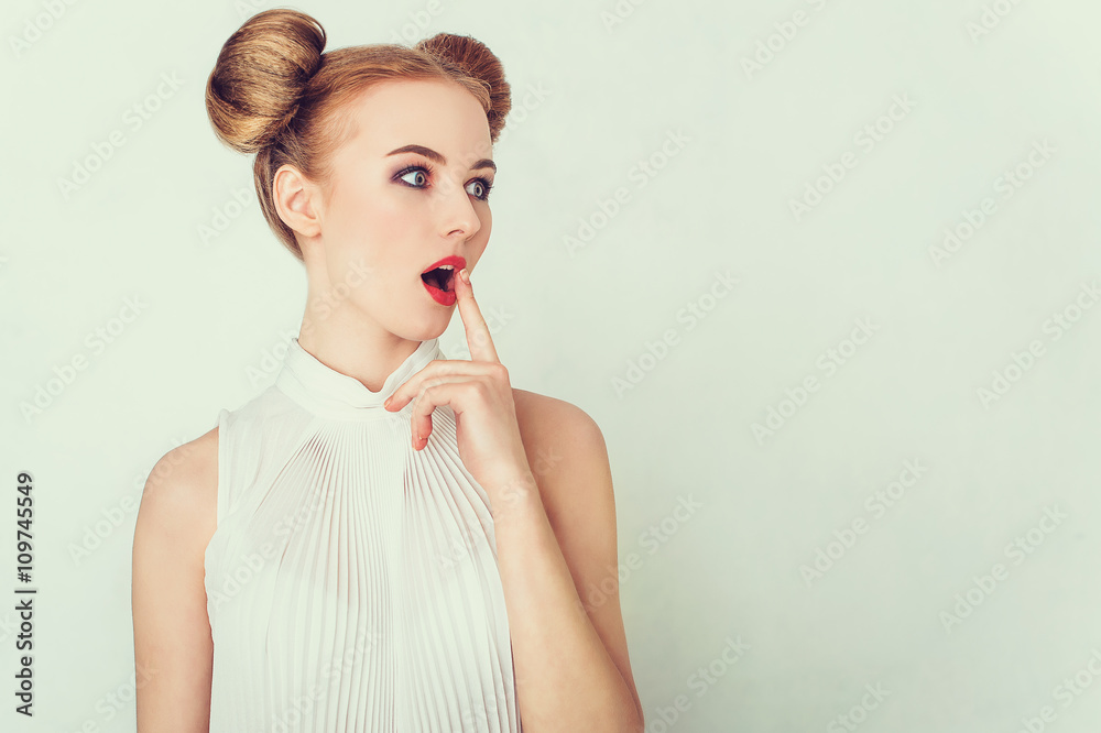 Close-up portrait of surprised beautiful girl with funny hairstyle. Sly and scheming young woman face expression. Close-up portrait of surprised beautiful girl with funny hairstyle. Sly and scheming young woman face expression.