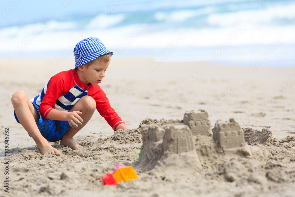 little boy play with sand on summer beach little boy play with sand on summer beach