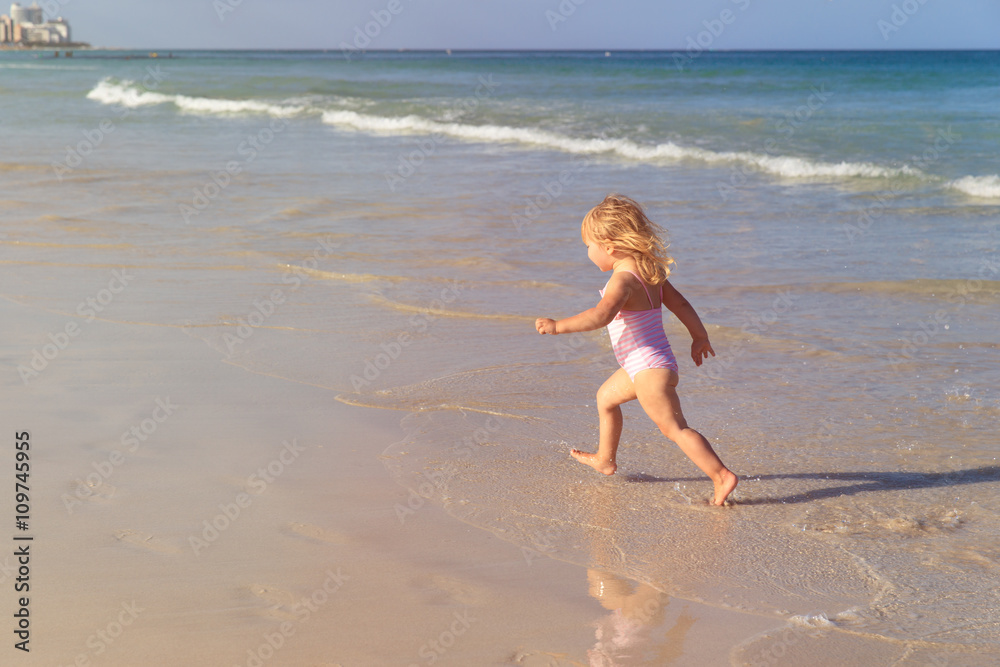 little girl run play with waves on the beach little girl run play with waves on the beach