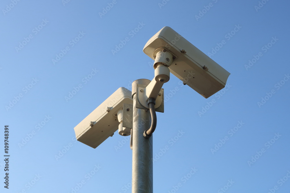 Outdoor security CCTV camera on blue sky background Outdoor security CCTV camera on blue sky background