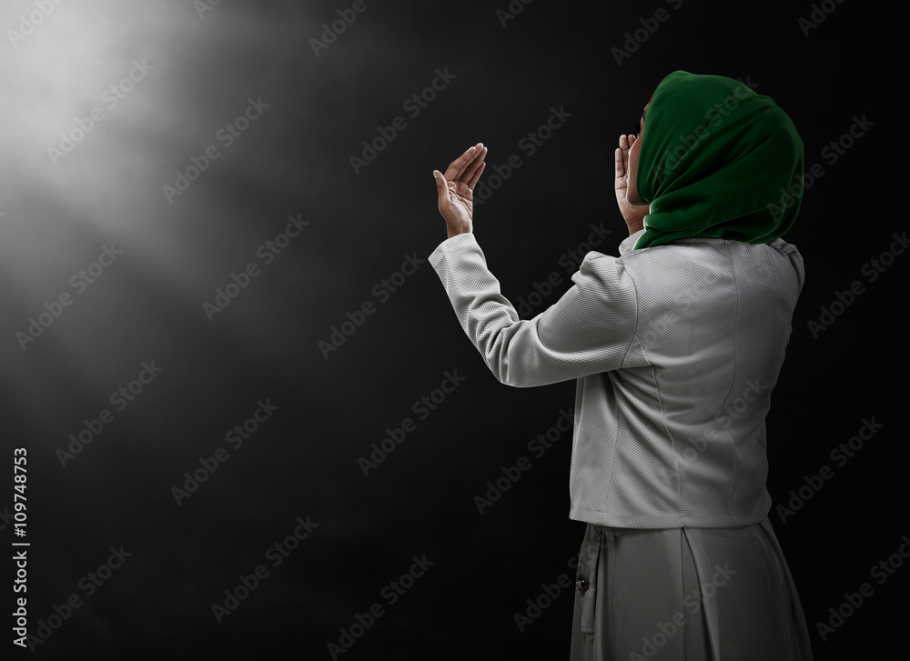 Back view of muslim woman praying Back view of muslim woman praying