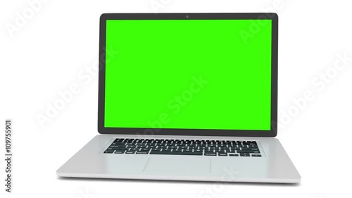 Isolated laptop with green screen on white background. Camera rotating around notebook. Template empty green screen.