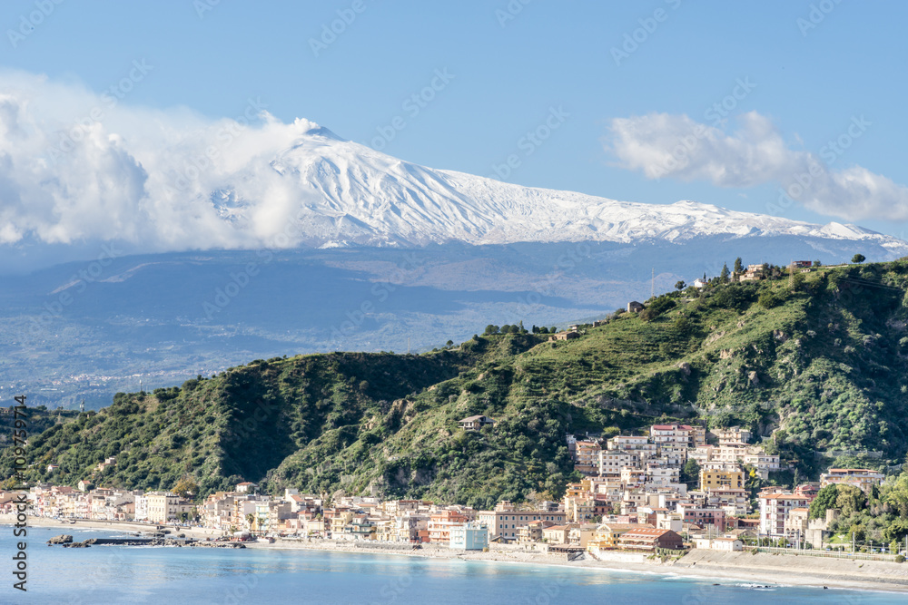 The bay of Giardini-Naxos with the snowy Mount Etna in the background. Winter view from Taormina. Province of Messina. Sicily, Italy.