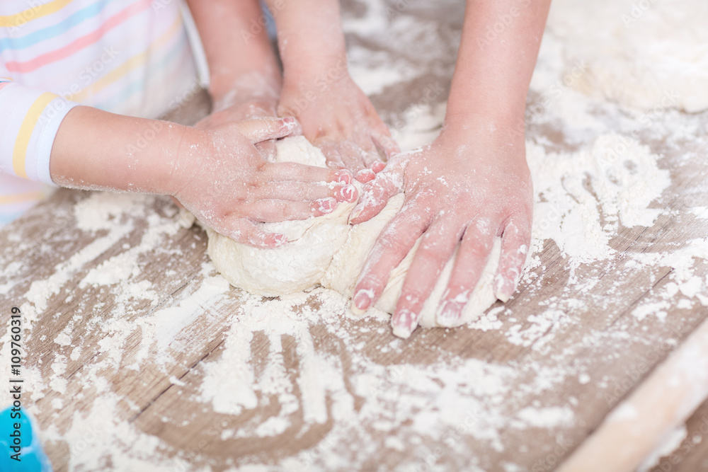 Family hands together working on dough Family hands together working on dough