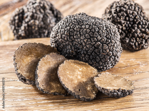 Black truffles on the old wooden table.