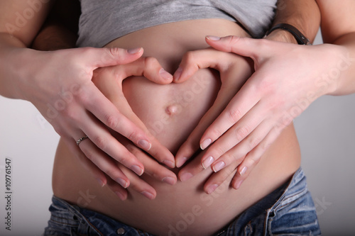Wallpaper Mural Hands of mom and dad a heart on pregnant belly Torontodigital.ca