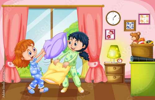 Two girls playing pillow fight