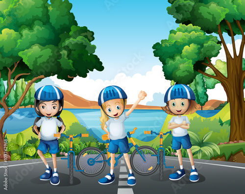 Three girls riding bike on the road