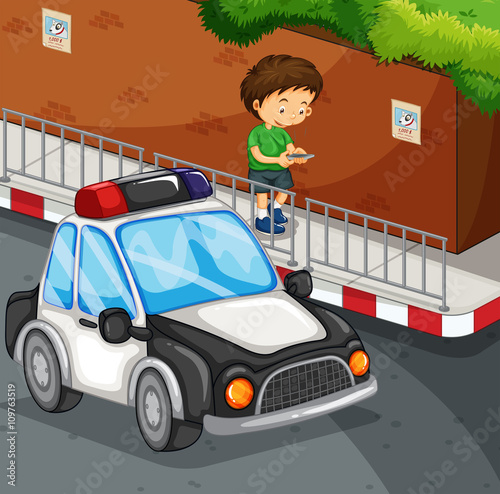 Boy typing on mobile phone on street
