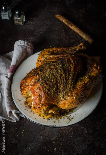 Roasted chicken with zatar or zaatar on dark background. Toned image. Selective focus. Arabic cuisine photo