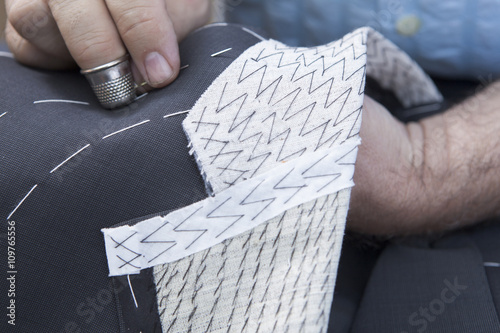 25 September 2012 at a tailor in Barcelona, Spain. Production process of suit tailoring, hand sewing of a tailored jacket