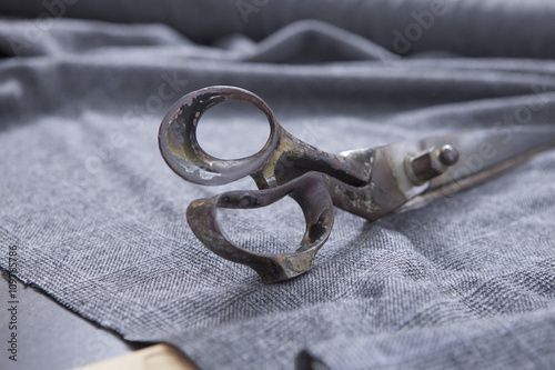 25 September 2012 at a tailor in Barcelona, Spain. Production process of suit tailoring. Still life of a tailoring scissors on woolen fabric.
