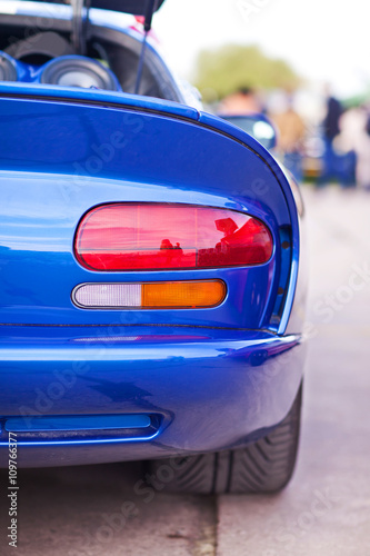 Rear side view of blue sport car photo