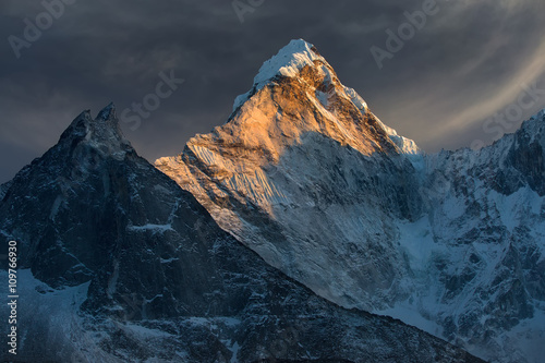 Majestic snowy mountain peak - Ama Dablam (6,812 m) is a one of the most beautiful and impressive peaks of our planet. photo